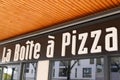 La boite ÃÂ  pizza logo and text sign front of Pizza restaurant Home Delivery and